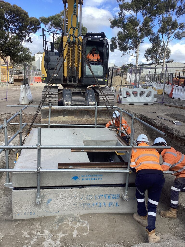 Construction workers installing underground infrastructure.