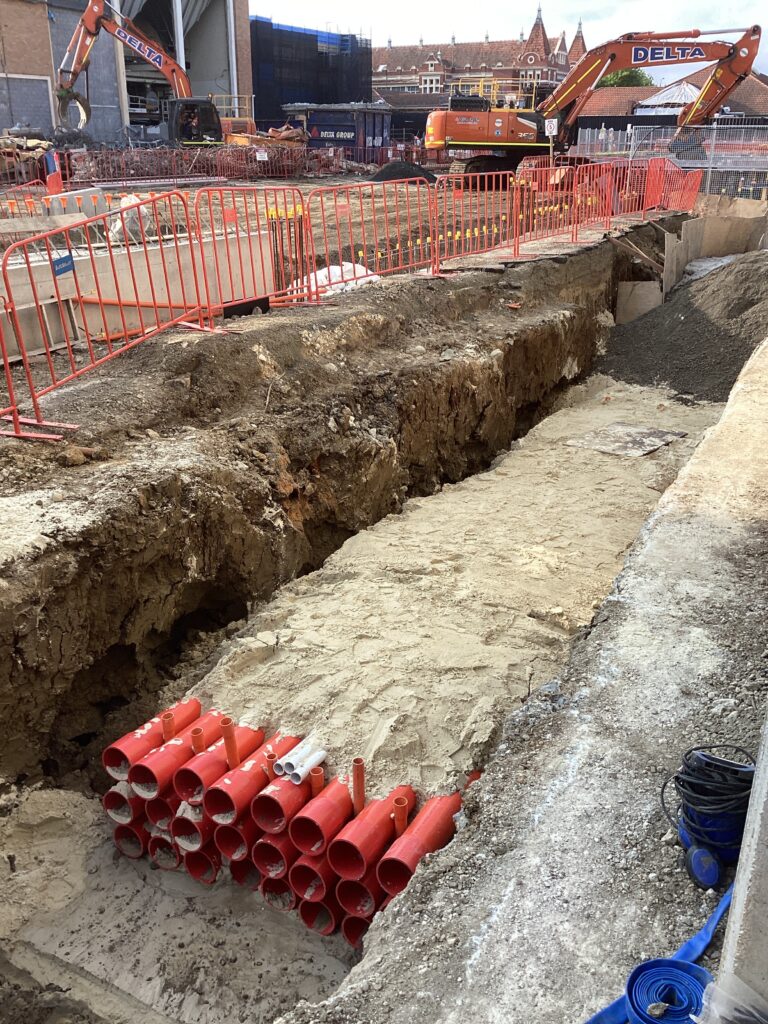 Construction site with trenches and pipes.