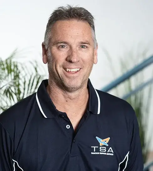 Smiling man in a TSA polo shirt