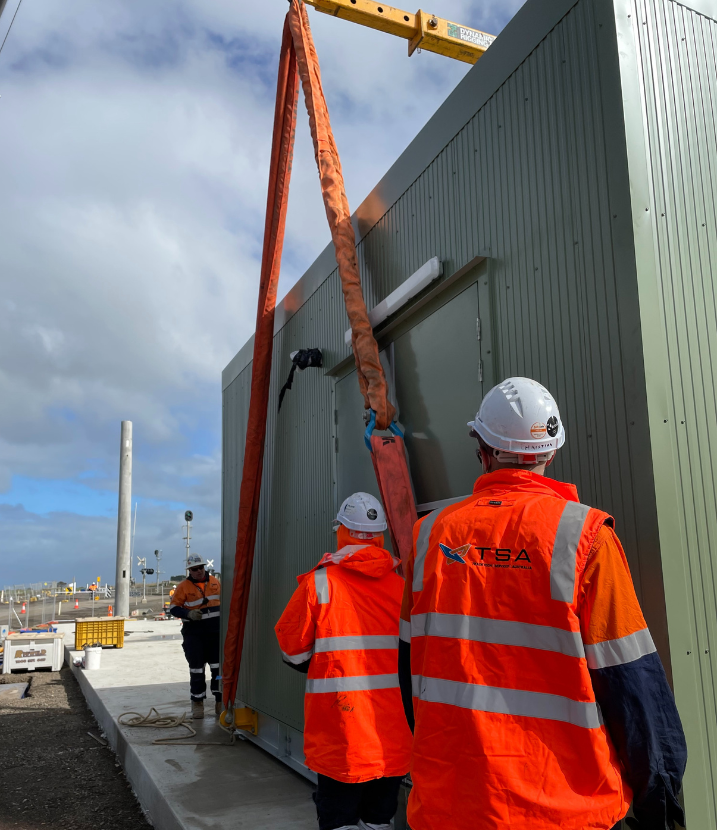 Construction site with workers and crane.
