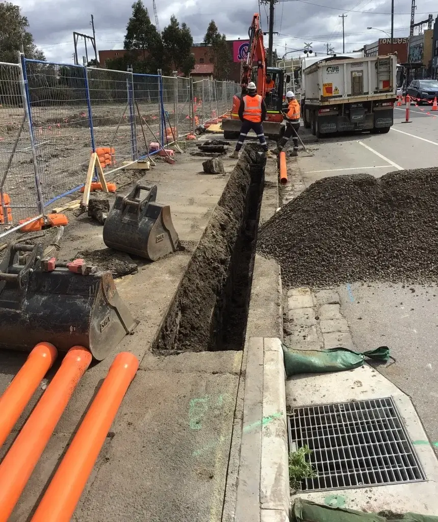 Excavator digging a trench on a construction site